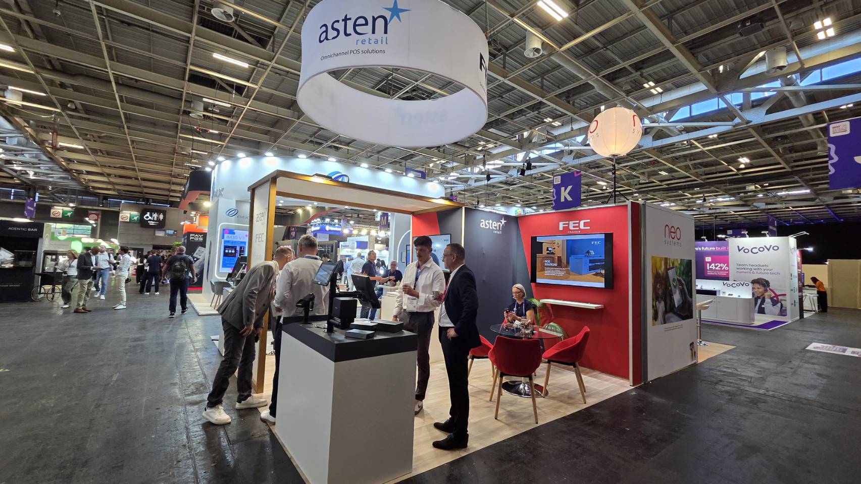 Wide view of the FEC and Asten Retail booth with visitors
