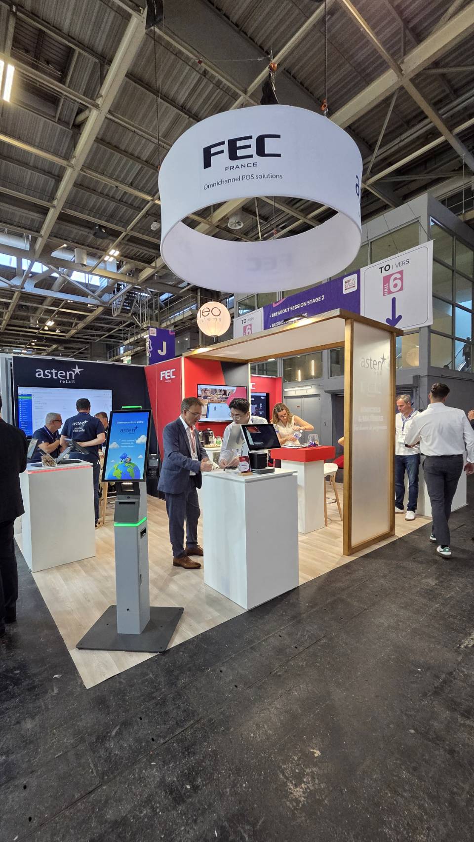 FEC France booth signage with visitors walking by at NRF Paris